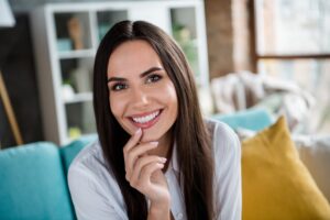 Happy woman showing off new veneers